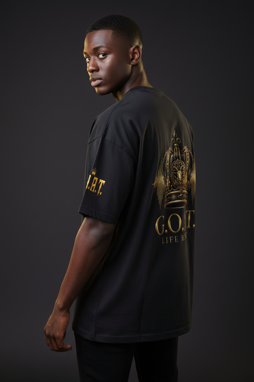 Black oversized cotton T-shirt with gold "G.O.A.T. Life Music" logo on the back