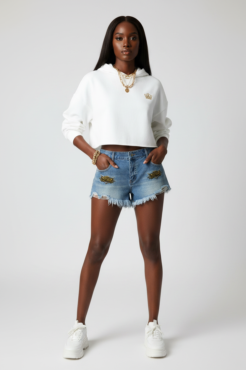 Light blue denim shorts with eagle patches and frayed raw hem